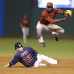  Arizona Diamondbacks' Didi Gregorius, right, jumps after getting Cleveland Indians' Jason Kipnis out at second base in the tenth inning of the second baseball game of a doubleheader, Wednesday, Aug. 13, 2014, in Cleveland. Gregorius was able to complete the double play to get Mike Aviles out at first base. (AP Photo/Tony Dejak)