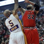 Chicago Bulls' Taj Gibson (22) goes up to shoot against Los Angeles Lakers' Carlos Boozer (5) during the first half of an NBA basketball game in Chicago, Thursday, Dec. 25, 2014. (AP Photo/Paul Beaty)