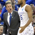 Kentucky head coach John Calipari, left, talks with Andrew Harrison during a timeout in the second half of an NCAA tournament college basketball game against Cincinnati, in Louisville, Ky., Saturday, March 21, 2015. (AP Photo/Timothy D. Easley)