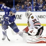 Chicago Blackhawks goalie Corey Crawford (50) blocks a shot by Tampa Bay Lightning left wing Ondrej Palat (18) during the third period of Game 5 of the NHL hockey Stanley Cup Final, Saturday, June 13, 2015, in Tampa, Fla. (AP Photo/Chris O'Meara)