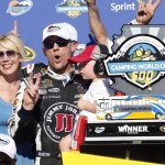 Kevin Harvick poses with his wife DeLana, left, and son Keelan, after winning a NASCAR Sprint Cup Series auto race on Sunday, March 15, 2015, in Avondale, Ariz. (AP Photo/Rick Scuteri)