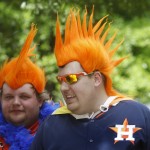 Adam Allred and Chad Carlson walk through the Opening Day Festival before a baseball game between the Houston Astros and Cleveland Indians, Monday, April 6, 2015, in Houston. (AP Photo/Patric Schneider)
