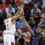 Utah guard Brandon Taylor, left, shoots over Stephen F. Austin guard Dallas Cameron during the second half of an NCAA college basketball second-round game in Portland, Ore., Thursday, March 19, 2015. (AP Photo/Craig Mitchelldyer)