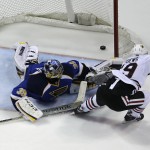 Chicago Blackhawks' Jonathan Toews, right, scores the game-winning goal past St. Louis Blues goalie Ryan Miller during overtime in Game 5 of a first-round NHL hockey playoff series Friday, April 25, 2014, in St. Louis. The Blackhawks one 3-2. (AP Photo/Jeff Roberson)