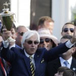 Trainer Bob Baffert holds up the winning trophy after the 141st running of the Kentucky Derby horse race at Churchill Downs Saturday, May 2, 2015, in Louisville, Ky. (AP Photo/Brynn Anderson)