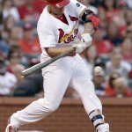 St. Louis Cardinals' Matt Holliday hits an RBI single during the first inning of a baseball game against the Arizona Diamondbacks on Tuesday, May 26, 2015, in St. Louis. (AP Photo/Jeff Roberson)