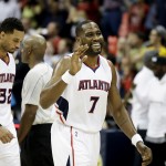 Atlanta Hawks' Elton Brand, right, smiles as he walks off the court to high-five teammates after the Hawks beat the Phoenix Suns 96-69 in an NBA basketball game to set a single-season franchise high with their 58th victory Tuesday, April 7, 2015, in Atlanta. (AP Photo/David Goldman)