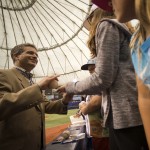 Tampa Bay Rays principal owner Stuart Sternberg signs baseballs as he talks with fans before an opening day baseball game against the Baltimore Orioles Monday, April 6, 2015, in St. Petersburg, Fla. (AP Photo/Steve Nesius)