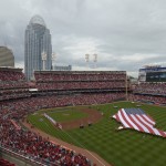 Pittsburgh Pirates and Cincinnati Reds players line the baseline during the singing of the National anthem before their Opening day baseball game played Monday, April 6, 2015 in Cincinnati. (AP Photo/Michael E. Keating)