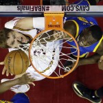Cleveland Cavaliers center Timofey Mozgov (20) puts up a shot against Golden State Warriors forward Draymond Green (23) during the first half of Game 6 of basketball's NBA Finals in Cleveland, Tuesday, June 16, 2015. (AP Photo/Tony Dejak)
