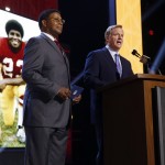 NFL commissioner Roger Goodell, right, introduces former Washington Redskins player Brig Owens as Owens gets ready to announce that the Redskins selects Mississippi State defensive lineman Preston Smith as the 38th pick in the second round of the 2015 NFL Football Draft, Friday, May 1, 2015, in Chicago. (AP Photo/Charles Rex Arbogast)