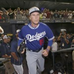 Actor Will Ferrell exits the dugout wearing a Los Angeles Dodgers uniform as he comes in to pitch in a spring training baseball game between the Dodgers and the San Diego Padres on Thursday, March 12, 2015, in Peoria, Ariz. (AP Photo/Lenny Ignelzi)
