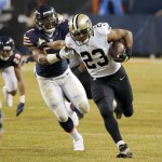 New Orleans Saints running back Pierre Thomas (23) carries the ball against Chicago Bears outside linebacker Jon Bostic (57) during the first half of an NFL football game Monday, Dec. 15, 2014, in Chicago. (AP Photo/Charles Rex Arbogast)