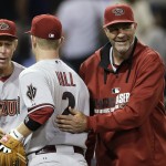 Arizona Diamondbacks manager Kirk Gibson, right, and bench coach Alan Trammell, left, congratulate second baseman Aaron Hill (2) after the Diamondbacks defeated the San Diego Padres 5-1 in a baseball game Thursday, Sept. 4, 2014, in San Diego. (AP Photo/Gregory Bull)