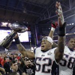 New England Patriots' Jonathan Casillas (52) holds up the Vince Lombardi Trophy as he celebrates with linebacker Darius Fleming (58) after the NFL Super Bowl XLIX football game against the Seattle Seahawks Sunday, Feb. 1, 2015, in Glendale, Ariz. The Patriots won 28-24. (AP Photo/Matt Slocum)