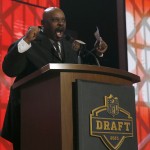 Former NFL player Cincinnati Bengals Ickey Woods announces that the Cincinnati Bengals selects Oregon offensive lineman Jake Fisher as the 53rd pick in the second round of the 2015 NFL Football Draft, Friday, May 1, 2015, in Chicago. (AP Photo/Charles Rex Arbogast)