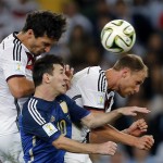 Germany's Mats Hummels, left, Argentina's Lionel Messi, center, and Germany's Benedikt Hoewedes go for a header during the World Cup final soccer match between Germany and Argentina at the Maracana Stadium in Rio de Janeiro, Brazil, Sunday, July 13, 2014. (AP Photo/Frank Augstein)