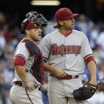  Arizona Diamondbacks starting pitcher Mike Bolsinger, right, and catcher Miguel Montero look at the scoreboard during the fifth inning of a baseball game against the Los Angeles Dodgers, Saturday, April 19, 2014, in Los Angeles. (AP Photo/Jae C. Hong)