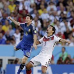 Argentina's Lionel Messi, left, and Germany's Mats Hummels go for an header during the World Cup final soccer match between Germany and Argentina at the Maracana Stadium in Rio de Janeiro, Brazil, Sunday, July 13, 2014. (AP Photo/Victor R. Caivano)