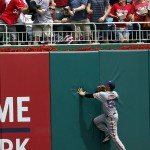 The fans and San Francisco Giants left fielder Ryan Lollis can't catch a solo home run by Washington Nationals' Michael Taylor during the first inning of a baseball game at Nationals Park, Saturday, July 4, 2015, in Washington. (AP Photo/Alex Brandon)
