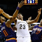New Orleans Pelicans forward Anthony Davis (23) and Phoenix Suns forwards Markieff Morris (11) and P.J. Tucker (17) go for a rebound during the second half of an NBA basketball game, Tuesday, Dec. 30, 2014, in New Orleans. The Pelicans won 110-106. (AP Photo/Jonathan Bachman)