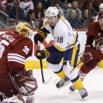 Arizona Coyotes' Louis Domingue (35) makes a save on a shot by Nashville Predators' James Neal (18) as Coyotes' Klas Dahlbeck (34), of Sweden, defends during the first period of an NHL hockey game Monday, March 9, 2015, in Glendale, Ariz. (AP Photo/Ross D. Franklin)