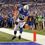 Indianapolis Colts tight end Coby Fleener scores a touchdown against the Washington Redskins on a pass from quarterback Andrew Luck during the first half of an NFL football game Sunday, Nov. 30, 2014, in Indianapolis. (AP Photo/AJ Mast)