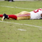 San Francisco 49ers outside linebacker Ahmad Brooks lies on the field after giving up a first down and missing a sack on Arizona Cardinals quarterback Drew Stanton during the second half of an NFL football game, Sunday, Sept. 21, 2014, in Glendale, Ariz. The Cardinals won 23-14. (AP Photo/Ross D. Franklin)