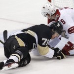 Pittsburgh Penguins' Evgeni Malkin (71) slides into Arizona Coyotes' Connor Murphy (5) during the first period of an NHL hockey game in Pittsburgh, Saturday, March 28, 2015. (AP Photo/Gene J. Puskar)
