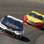 Kevin Harvick (4) leads Joey Logano in the 65th lap during a NASCAR Sprint Cup Series auto race on Sunday, March 15, 2015, in Avondale, Ariz. (AP Photo/Rick Scuteri)