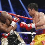 Manny Pacquiao, from the Philippines, right, trades blows with Floyd Mayweather Jr., during their welterweight title fight on Saturday, May 2, 2015 in Las Vegas. (AP Photo/John Locher)
