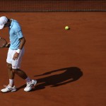 Serbia's Novak Djokovic bows his head as he plays Spain's Rafael Nadal during their final match of the French Open tennis tournament at the Roland Garros stadium, in Paris, France, Sunday, June 8, 2014. (AP Photo/David Vincent)