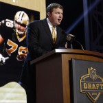 New Orleans Saints offensive tackle Jon Stinchcomb announces that the New Orleans Saints selects Washington linebacker Hau'Oli Kikaha as the 44th pick in the second round of the 2015 NFL Football Draft, Friday, May 1, 2015, in Chicago. (AP Photo/Charles Rex Arbogast)