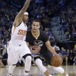 Golden State Warriors' Stephen Curry drives against Phoenix Suns' Isaiah Thomas during the second half of an NBA basketball game Saturday, Jan. 31, 2015, in Oakland, Calif. Golden State won 106-87. (AP Photo/Marcio Jose Sanchez)