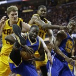 Golden State Warriors forward Draymond Green (23) comes up with a rebound next to teammate Harrison Barnes and Cleveland Cavaliers center Timofey Mozgov (20), top, left, and center Tristan Thompson (13), top right, forward Harrison Barnes (40) go up for a rebound during the first half of Game 4 of basketball's NBA Finals in Cleveland, Thursday, June 11, 2015. (AP Photo/Tony Dejak)