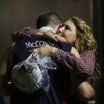 Arizona guard T.J. McConnell hugs Amy Miller, the wife of Arizona head coach Sean Miller, after Arizona lost 85-78 to Wisconsin in a college basketball regional final in the NCAA Tournament, Saturday, March 28, 2015, in Los Angeles. (AP Photo/Jae C. Hong)