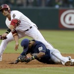  Arizona Diamondbacks' Martin Prado, left, collides with Milwaukee Brewers' Jean Segura after Prado was forced out at second base during the first inning of a baseball game on Tuesday, June 17, 2014, in Phoenix. (AP Photo/Ross D. Franklin)