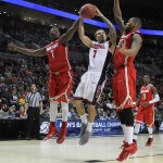 Arizona guard Gabe York, center, goes to the hoop against Ohio State forward Jae'Sean Tate, left, and Amir Williams during an NCAA college basketball tournament round of 32 game in Portland, Ore., Saturday, March 21, 2015. (AP Photo/Craig Mitchelldyer)