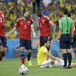 Colombia's Mario Yepes reacts as Brazil's Fred sits on the ground after being fouled during the World Cup quarterfinal soccer match between Brazil and Colombia at the Arena Castelao in Fortaleza, Brazil, Friday, July 4, 2014. (AP Photo/Hassan Ammar)
