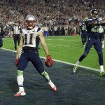 New England Patriots wide receiver Julian Edelman (11) reacts after catching a three-yard touchdown pass during the second half of NFL Super Bowl XLIX football game against the Seattle Seahawks Sunday, Feb. 1, 2015, in Glendale, Ariz. (AP Photo/David J. Phillip)