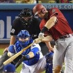 Arizona Diamondbacks' Paul Goldschmidt hits a two-run home run as Los Angeles Dodgers catcher Yasmani Grandal and home plate umpire Gerry Davis watch during the fifth inning of a baseball game, Wednesday, June 10, 2015, in Los Angeles. (AP Photo/Mark J. Terrill)