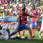 Costa Rica's goalkeeper Keylor Navas grabs the ball as England's Daniel Sturridge lies on the ground during the group D World Cup soccer match between Costa Rica and England at the Mineirao Stadium in Belo Horizonte, Brazil, Tuesday, June 24, 2014. At right is England's Jack Wilshere (7) and at center is Costa Rica's Oscar Duarte (6). (AP Photo/Martin Meissner)