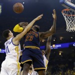 Cleveland Cavaliers forward LeBron James (23) loses the ball between Golden State Warriors guard Klay Thompson (11) and forward Harrison Barnes during the first half of Game 1 of basketball's NBA Finals in Oakland, Calif., Thursday, June 4, 2015. (AP Photo/Ben Margot)