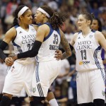 Minnesota Lynx forward Maya Moore (23), guard Seimone Augustus (33) and guard Lindsay Whalen (13) celebrate after taking over the lead in points during the second half of Game 2 of the WNBA basketball Western Conference finals against the Phoenix Mercury, Sunday, Aug. 31, 2014, in Minneapolis. The Lynx won 82-77. (AP Photo/Stacy Bengs)