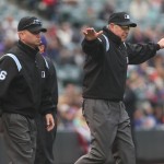  Crew chief Mike Winters, right, signals safe as first base umpire Mike Muchlinski looks on after a video replay to check if Colorado Rockies' leadoff hitter Charlie Blackmon slid safely into first base for a single against the Arizona Diamondbacks in the first inning of an MLB National League baseball game in Denver on Sunday, April 6, 2014. (AP Photo/David Zalubowski)