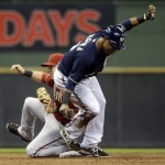 Arizona Diamondbacks shortstop Cliff Pennington tags out Milwaukee Brewers' Jean Segura trying to steal second during the second inning of a baseball game Wednesday, May 7, 2014, in Milwaukee. (AP Photo/Morry Gash)