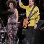 Carlos Santana, right, waves after he and his wife Cindy Blackman Santana performed the national anthem before Game 2 of basketball's NBA Finals between the Golden State Warriors and the Cleveland Cavaliers in Oakland, Calif., Sunday, June 7, 2015. (AP Photo/Ben Margot)