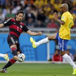 Germany's Mats Hummels, left, and Brazil's Maicon challenge for a ball during the World Cup semifinal soccer match between Brazil and Germany at the Mineirao Stadium in Belo Horizonte, Brazil, Tuesday, July 8, 2014. (AP Photo/Frank Augstein)