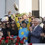 Victor Espinoza celebrates after riding American Pharoah to victory in the 141st running of the Kentucky Derby horse race at Churchill Downs Saturday, May 2, 2015, in Louisville, Ky. (AP Photo/Garry Jones)