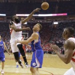 Houston Rockets' James Harden, second from left, passes the ball over Los Angeles Clippers' Blake Griffin, center, during the first half of Game 1 in a second-round NBA basketball playoff series Monday, May 4, 2015, in Houston. (AP Photo/David J. Phillip)